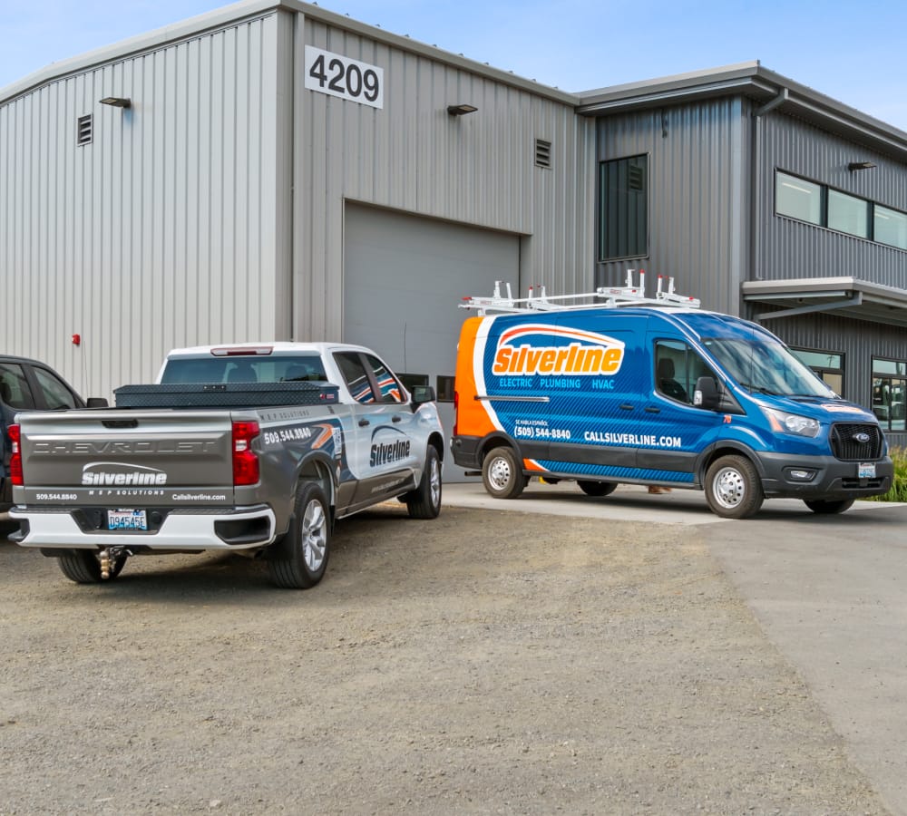 Silverline vehicles parked outside industrial building