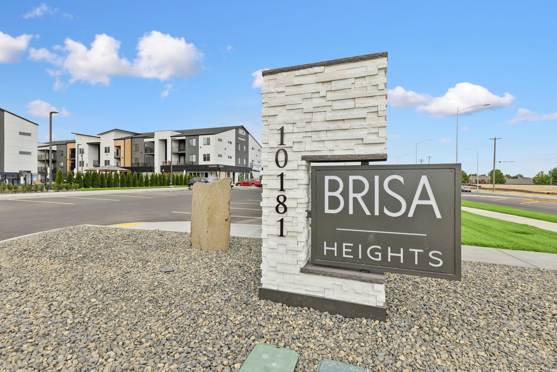 Brisa Heights apartment complex sign and building view.