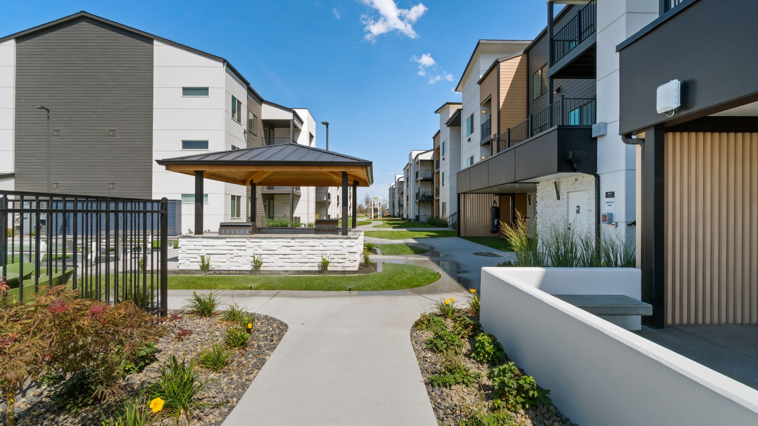 Modern apartment complex with garden pathway.