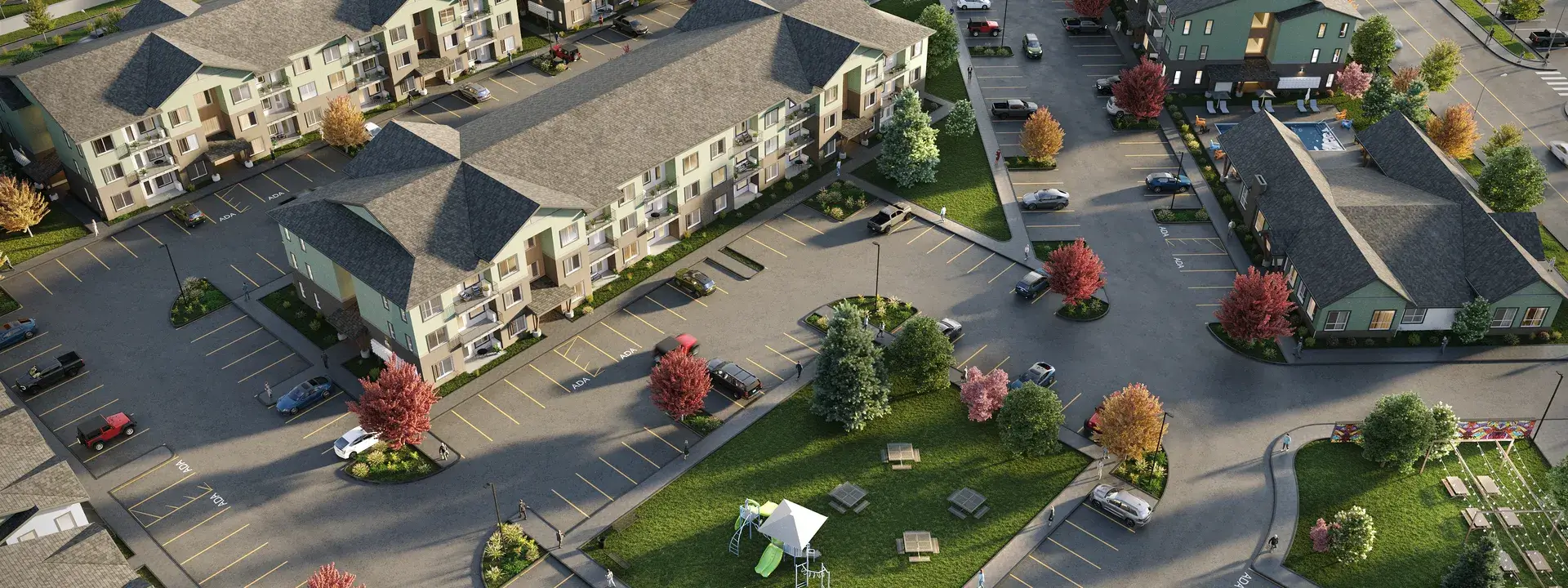 Aerial view of apartment complex with parking lot.