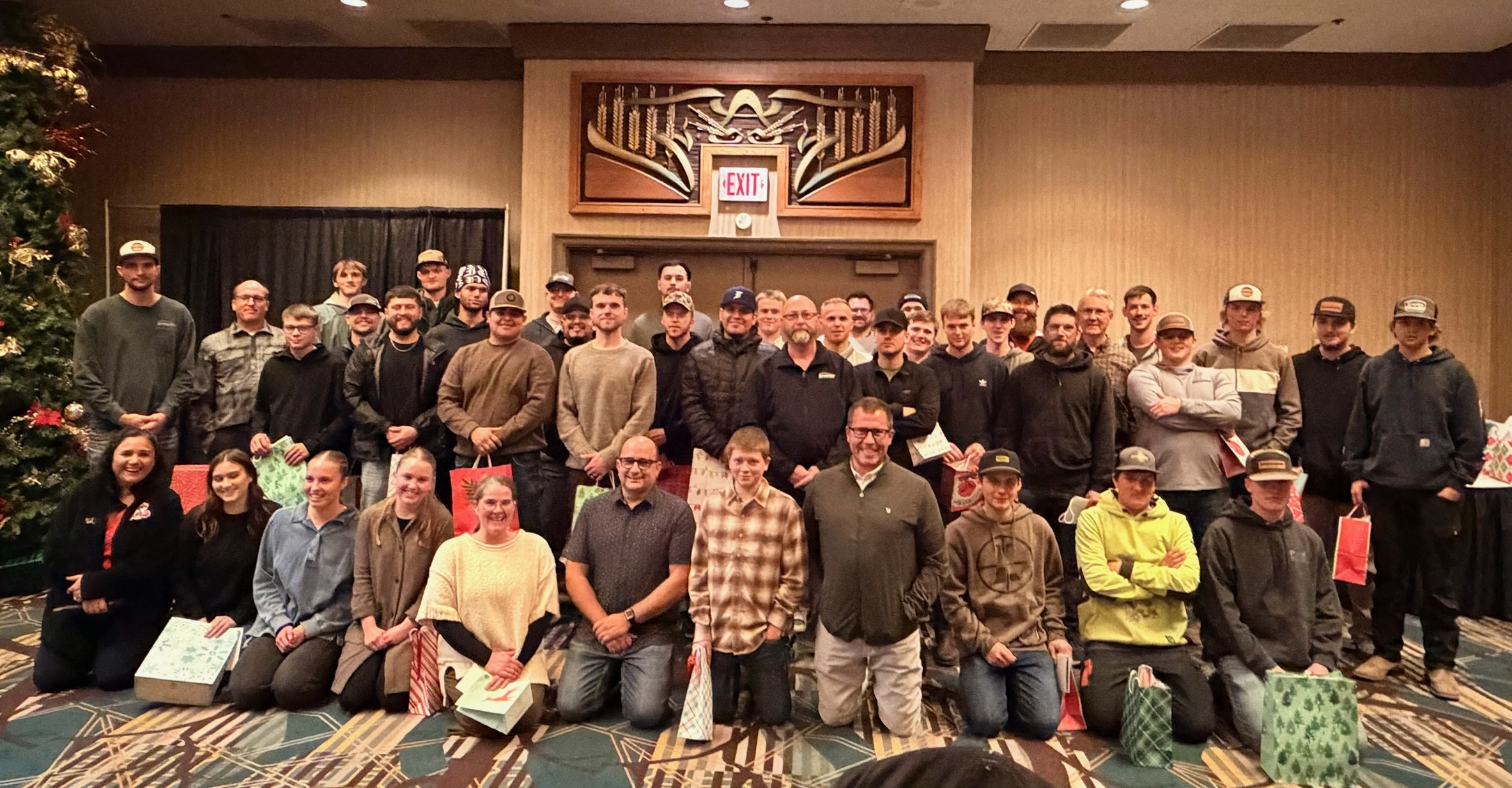 Large group gathered at a holiday event indoors.